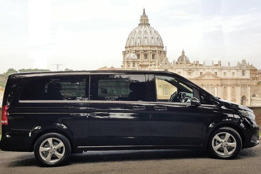 A black van parked in front of St. Peter's Basilica. 3