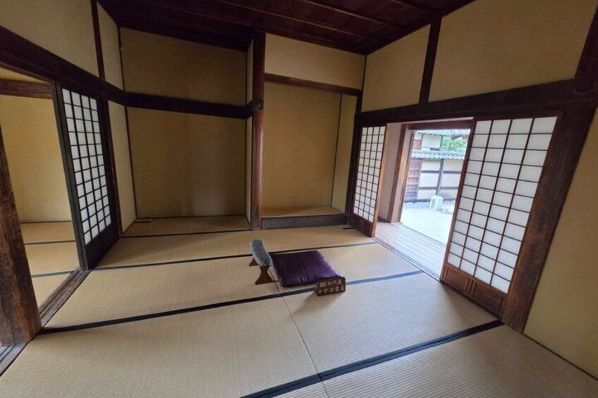 A traditional Japanese room with tatami flooring, sliding doors, and a low wooden table. 3