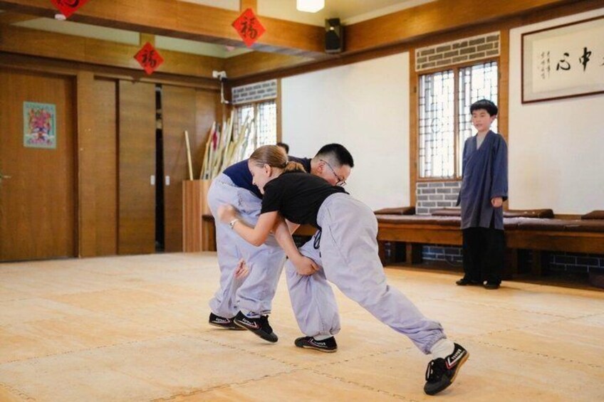 A martial arts training session with participants in traditional attire. 4