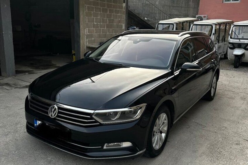 A black Volkswagen car parked in a garage. 4