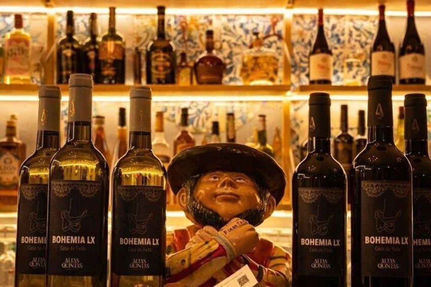 A bar with bottles labeled 'BOHEMIA LX' and a person wearing a hat. 4