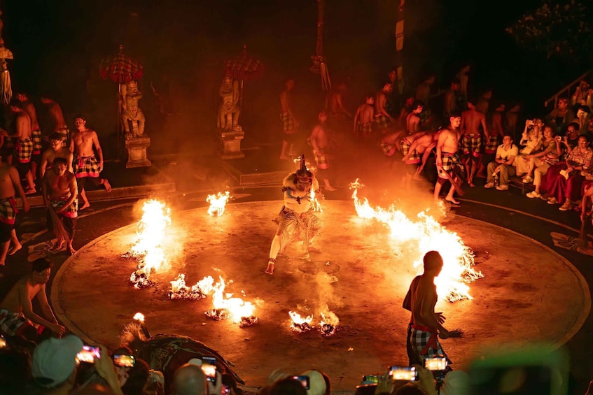 A fire performance with performers in traditional attire around a central fire. 3