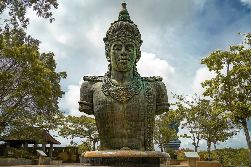 A large bronze statue of a historical figure with intricate details and a pedestal. 5