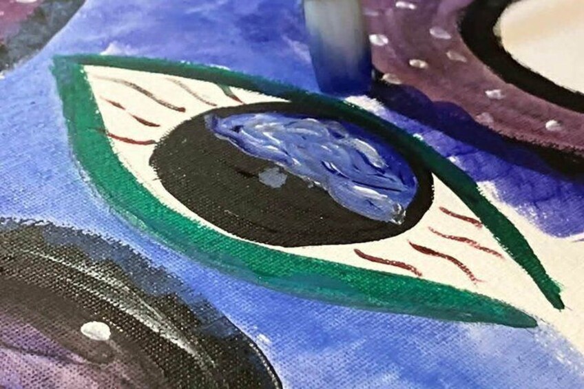A close-up of a painting with a prominent eye and a blue object. 4