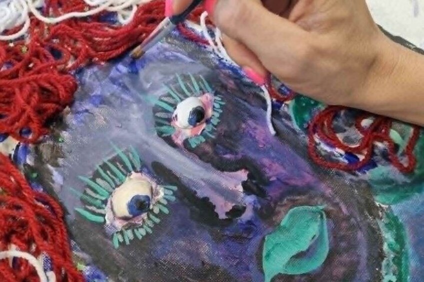 A person painting a canvas with abstract designs. 5