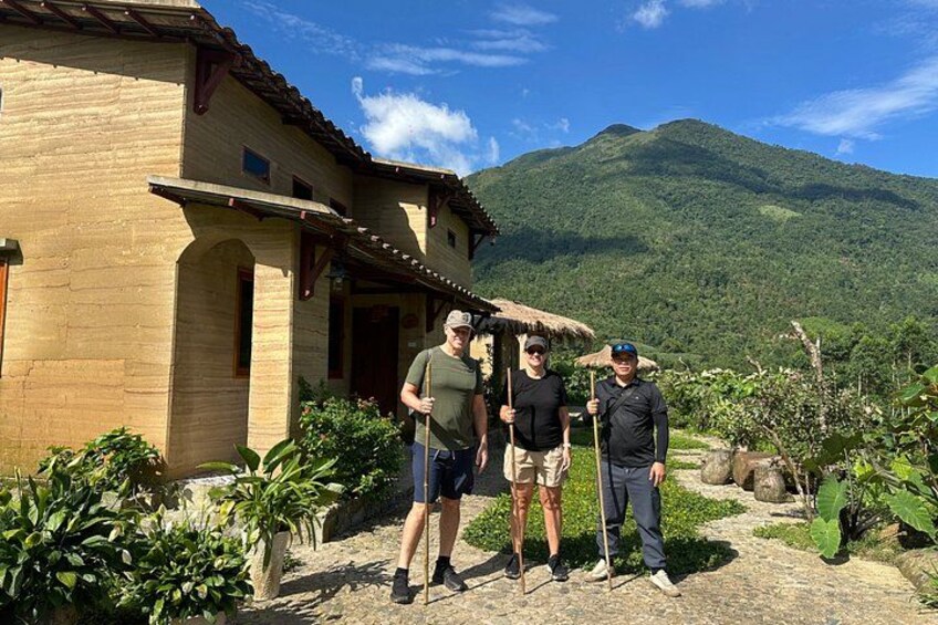 A rustic house with a stone facade, a thatched roof, and a mountainous backdrop. 3