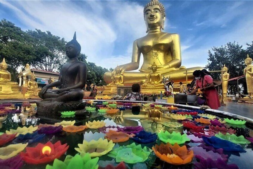 A large golden Buddha statue, a smaller seated Buddha, and a lotus pond with colorful lotus flowers. 3
