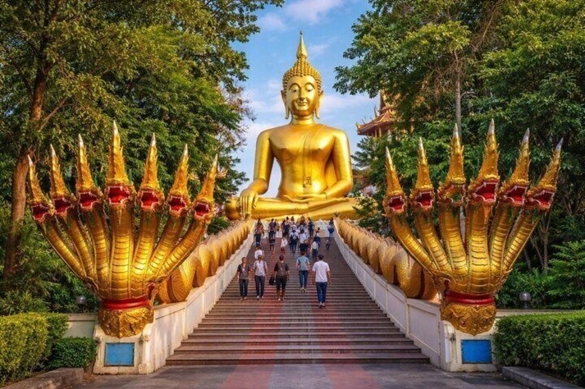 A large golden Buddha statue, flanked by ornate golden structures, with a staircase leading up to it. 2