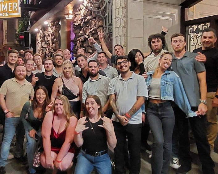 A group of people posing for a photo in an urban setting with decorative elements and a sign that reads 'THE SUMMER PLACE.' 4
