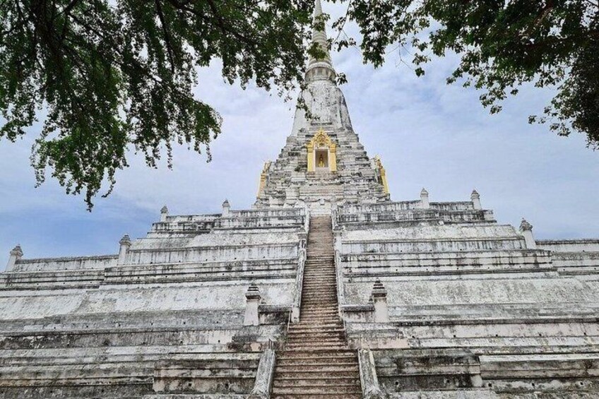 A temple with a central spire, a staircase leading up to it, and a large open courtyard. 5