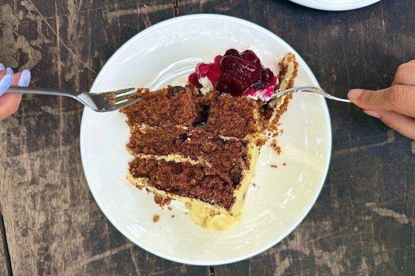 A slice of cake on a white plate with a fork. 2