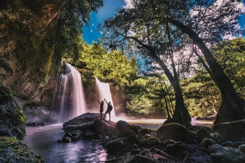 A waterfall, rocky terrain, and trees. 1