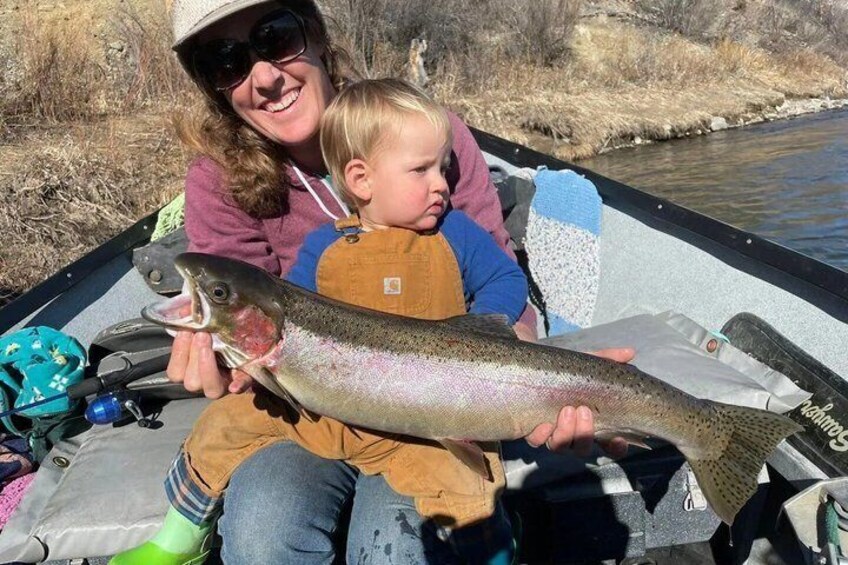 A person holding a large fish on a boat. 4