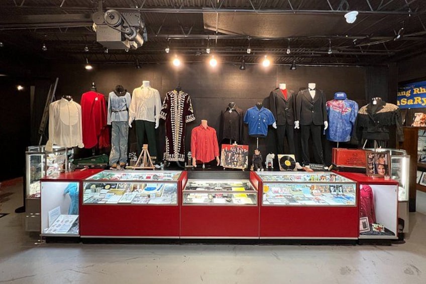 A clothing store with mannequins displaying various outfits. 2