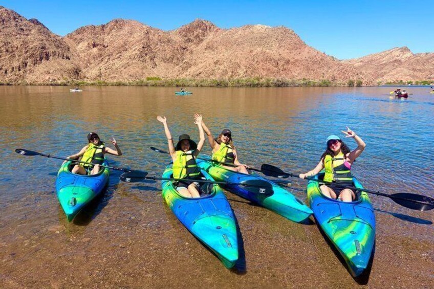 Three kayaks on a calm river with mountains in the background. 5