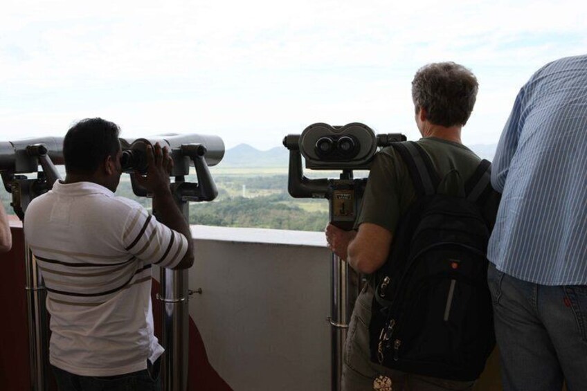 People using binoculars to view a landscape. 4