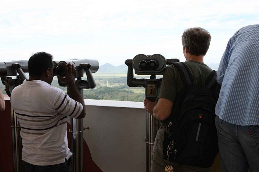 People using binoculars to view a landscape. 4