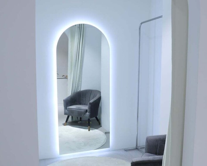 A modern interior with a grey armchair, a standing lamp, and a floor lamp. 5