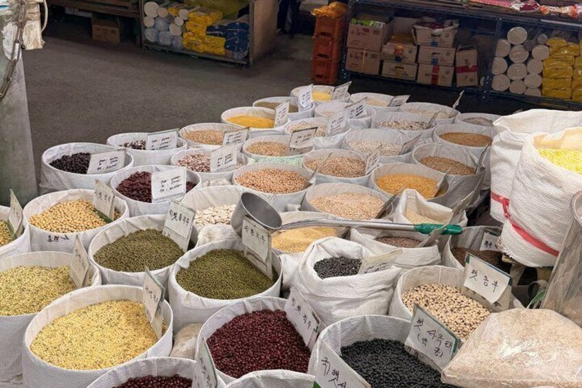 Various sacks of grains and legumes, likely at a market or wholesale setting. 5