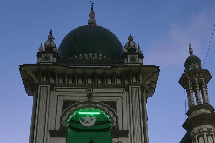 A building with a large dome and a green sign. 2