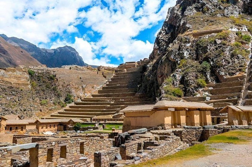 Ancient stone structures, terraced steps, and a mountainous landscape. 1