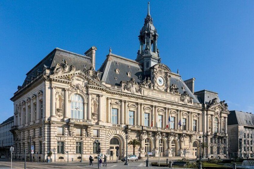 A historic building with ornate architecture, a clock tower, and a prominent entrance. 1