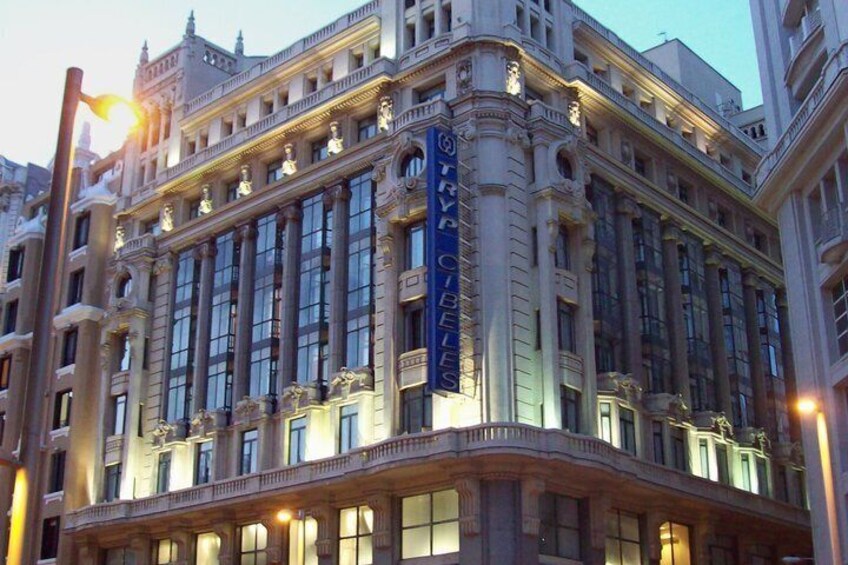 A grand, ornate building with large windows and a prominent sign reading 'TRYP CITIES.' 3