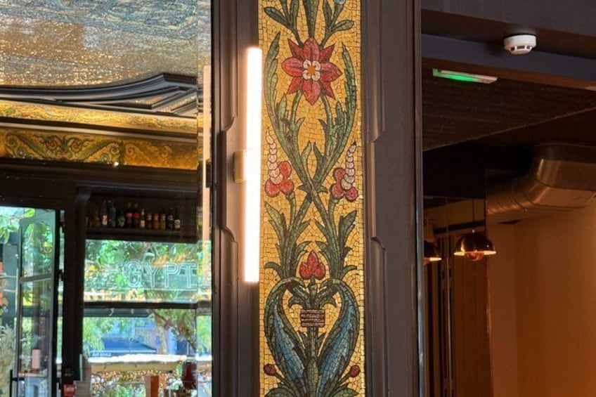 A stained glass window with floral patterns and a visible 'GYP' sign. 4