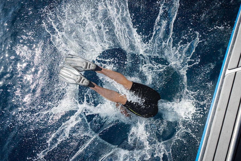 A person surfing on a wave with a surfboard. 4