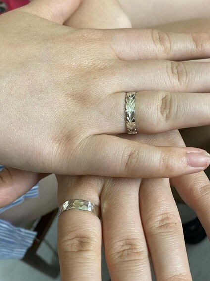 A person's hand with a ring on the ring finger. 3