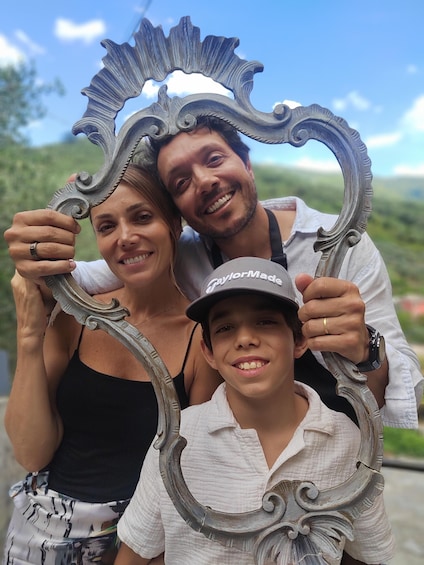 A family posing with a decorative mirror. 3