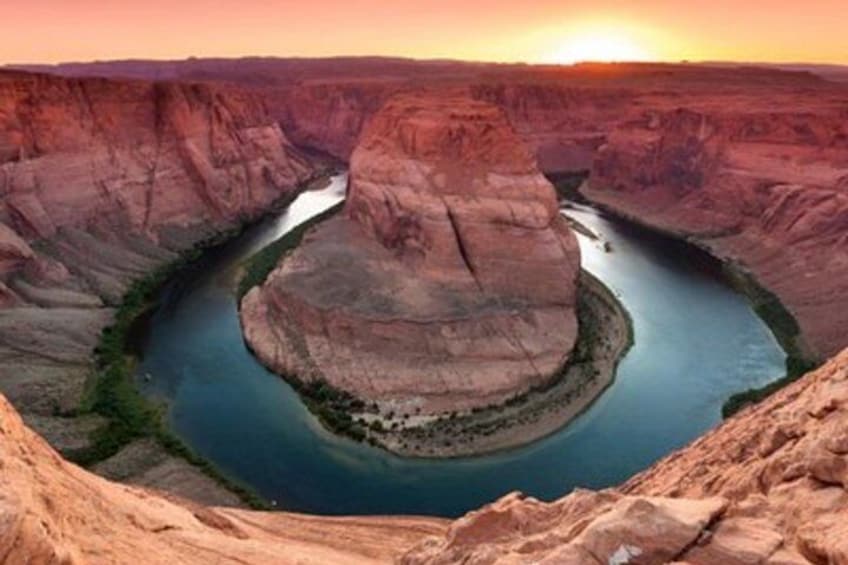 A river canyon with a circular rock formation and a sunset. 2