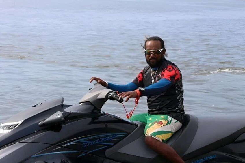 A person on a jet ski with a water body in the background. 3