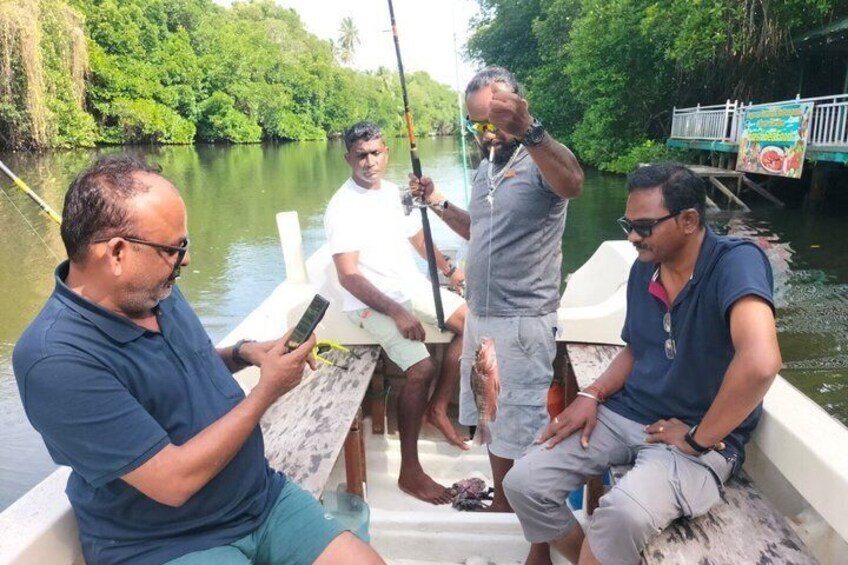 A group of people on a boat in a river surrounded by greenery. 2
