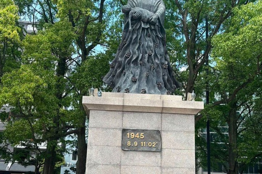 A statue with a plaque reading '1945 8.9 11:02'. 5