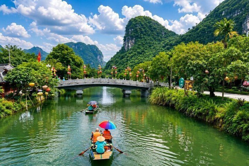 A river with boats, a bridge, and lush greenery. 1