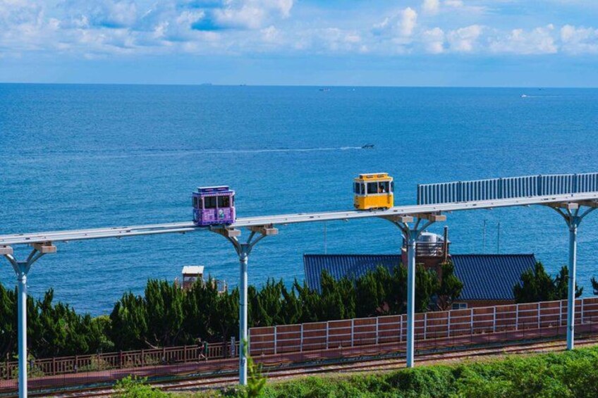 A cable car system over a body of water with a clear sky. 2