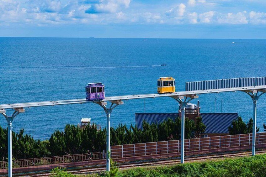 A cable car system over a body of water with a clear sky. 2