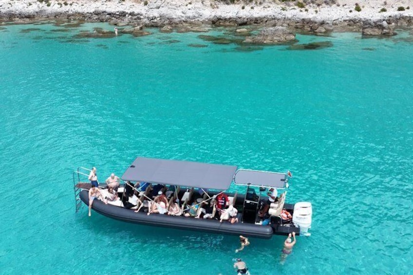 A boat with people on a turquoise sea. 3