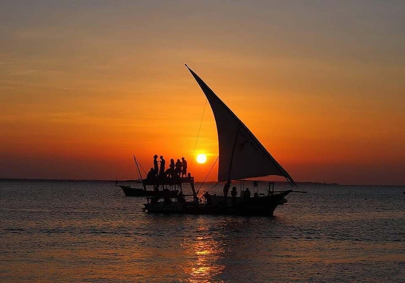 A boat with a sail at sunset. 3