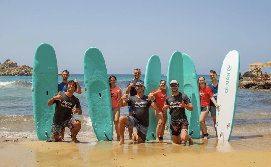 A group of people with surfboards on a beach. 1