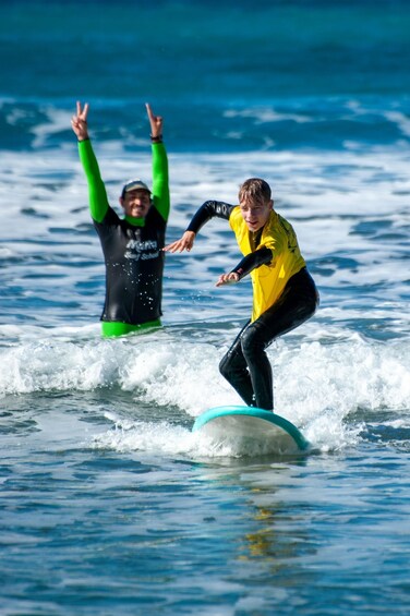 Two people surfing on a wave in the ocean. 5
