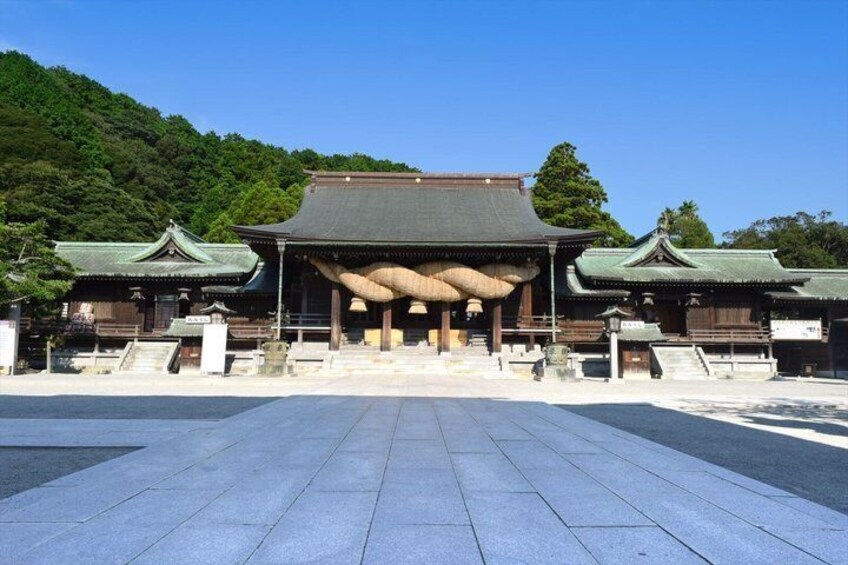 A traditional Japanese temple with a large central hall and two smaller buildings on either side. 2