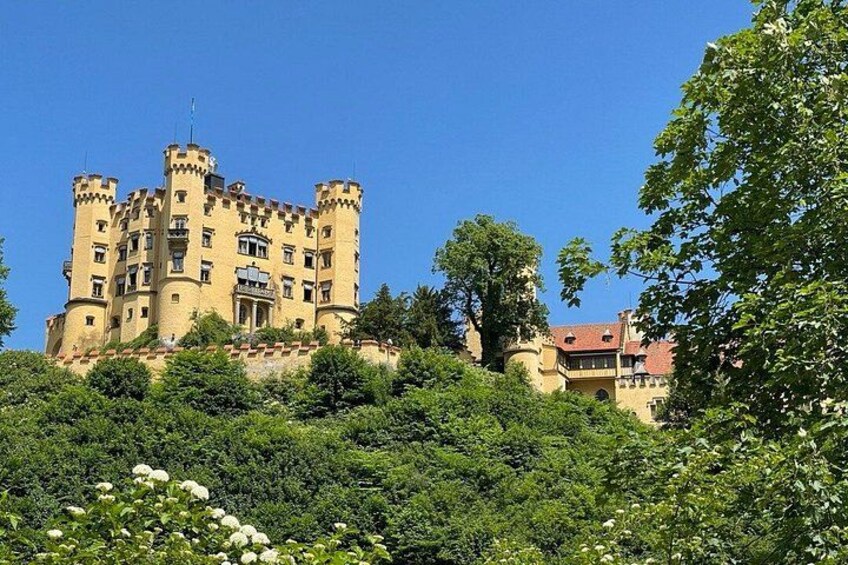 A castle with multiple towers, surrounded by lush greenery and trees. 4