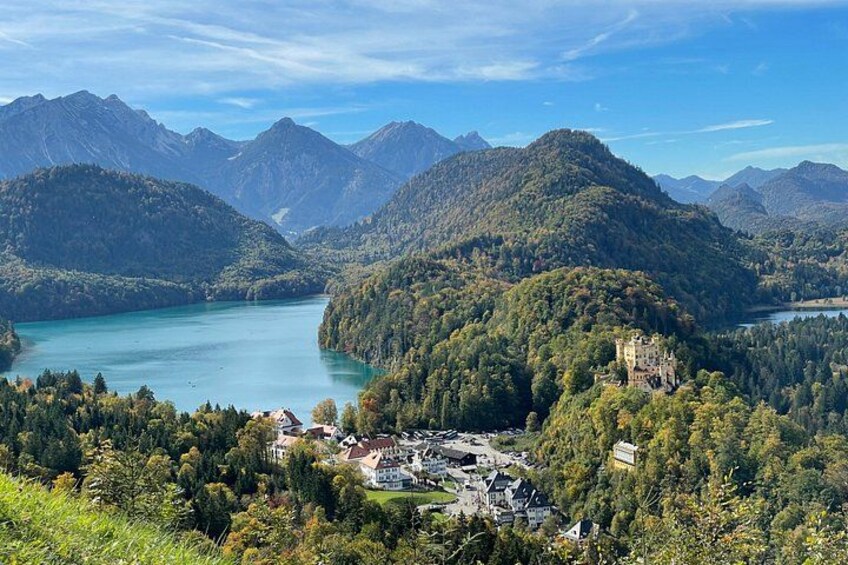 A mountainous landscape with a lake, a castle, and a village. 2
