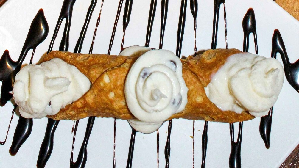 A dessert with whipped cream and chocolate drizzle. 2
