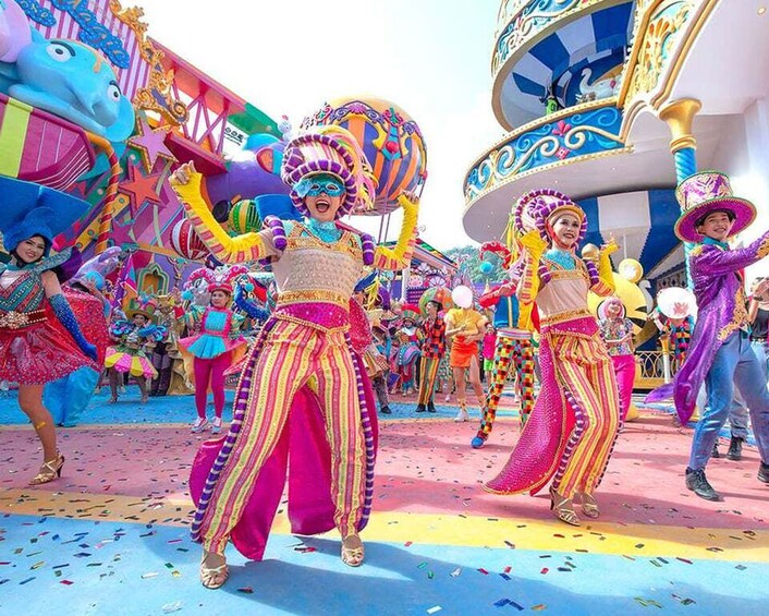 A colorful parade with performers in vibrant costumes and elaborate headpieces. 2