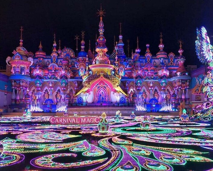 A brightly lit architectural structure with multiple domes and a central building, surrounded by a water fountain display. 3