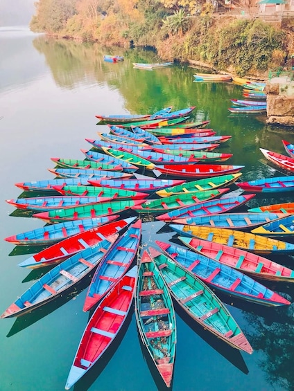 A circular arrangement of colorful boats on a calm river. 1