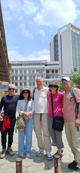 A group of people standing in front of the National School of Sciences building. 1